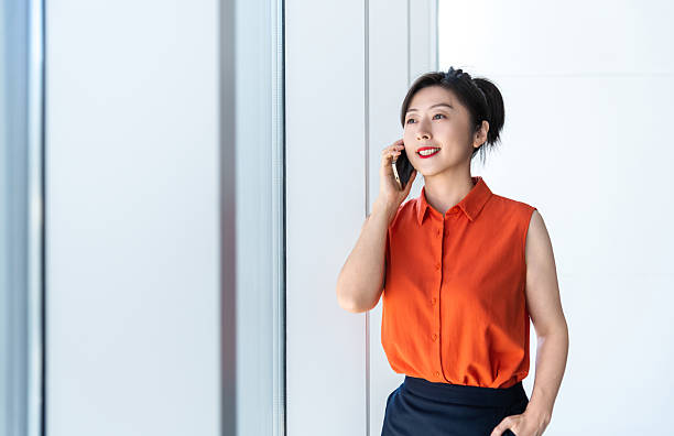 istock Businesswoman using smart phone near the window 2224464132