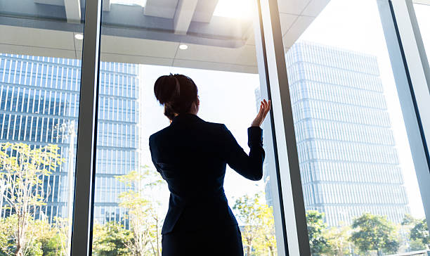 istock Businesswoman using smart phone near the window 2224464149
