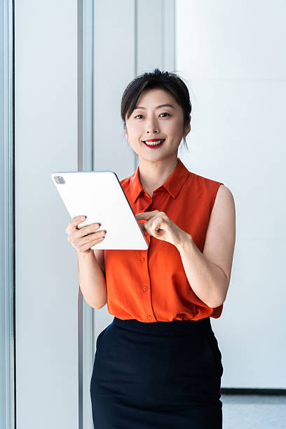 istock Businesswoman using digital tablet near the window 2224464191