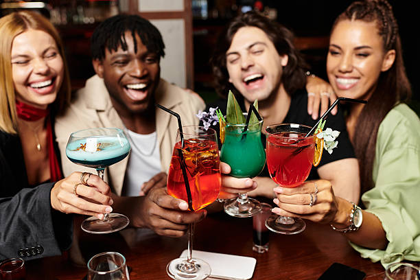 istock Young colleagues celebrate teamwork with cheerful drinks and laughter at a corporate gathering 2224466088