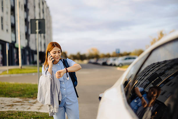 istock Cheerful female nurse uses smartphone while walking to work 2224467750