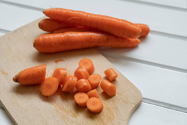 Freshly sliced organic carrots on cutting board
