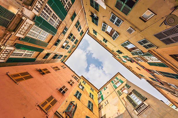 istock Colorful Genoa buildings frame the sky in a quiet old town courtyard 2224471672