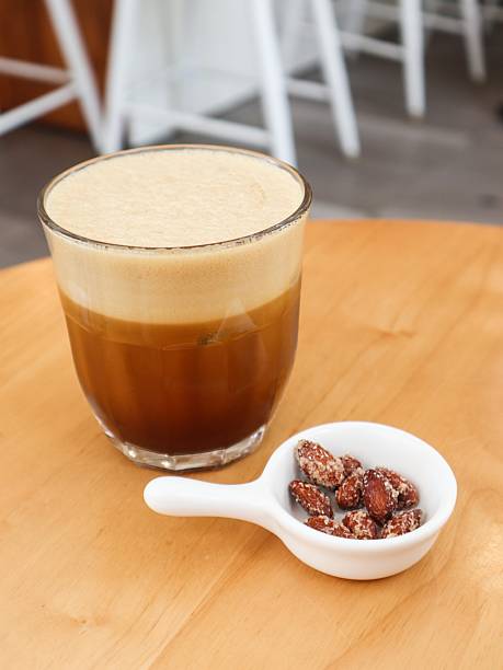 istock cold creamy black coffee with a layer of smooth foam on top and nuts on the side with copy space 2224472338