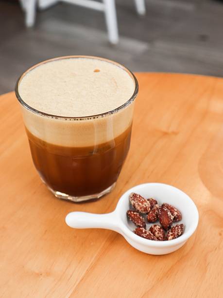 istock cold creamy black coffee with a layer of smooth foam on top and nuts on the side with copy space 2224472340