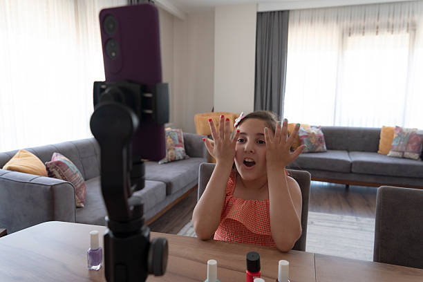 istock A talented young girl is showing cosmetic products while recording her make up tutorial 2224472391