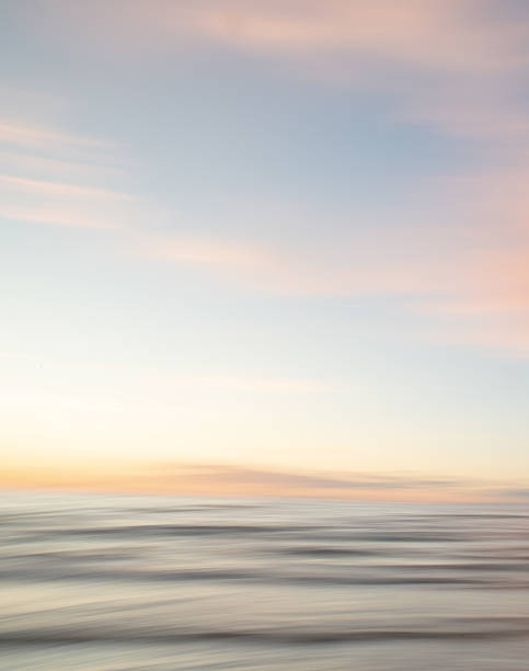 istock A dreamy, impressionistic paint like blurred sea sunset background with gently soft pastel colours. Vertical photo. 2224472870