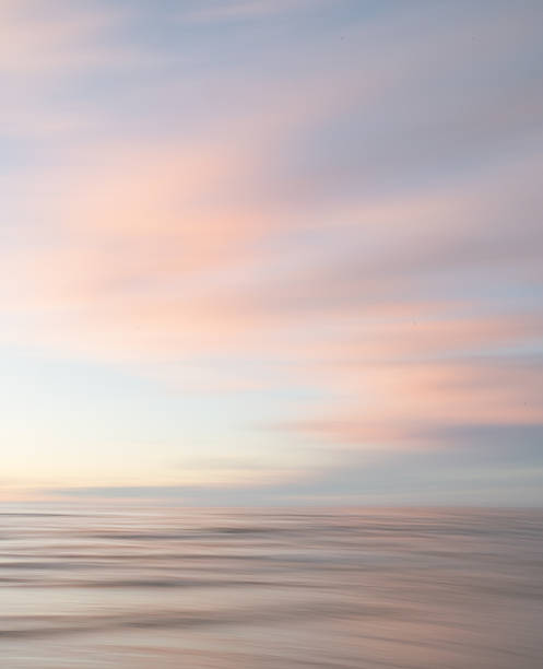 istock A dreamy, impressionistic paint like blurred sea sunset background with gently soft pastel colours. Vertical photo. 2224472982
