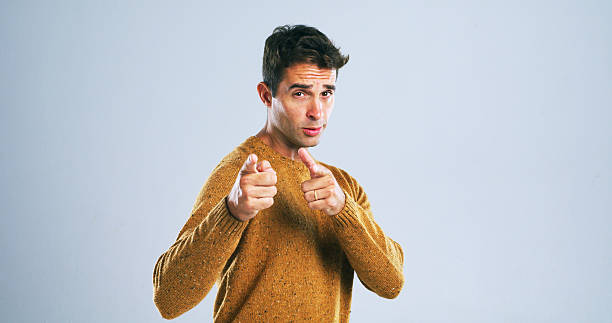 istock Portrait, man and pointing at you in studio for decision, selection or choice on white background. Finger gun, invitation and person with hand gesture for join us, hiring or recruit with mockup space 2224474935