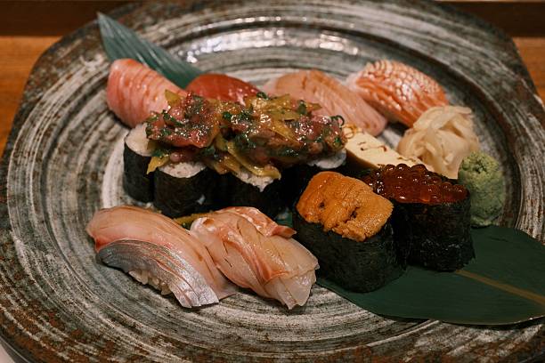 A beautifully arranged sushi platter featuring fresh nigiri and sashimi on a decorative plate with wasabi and ginger.