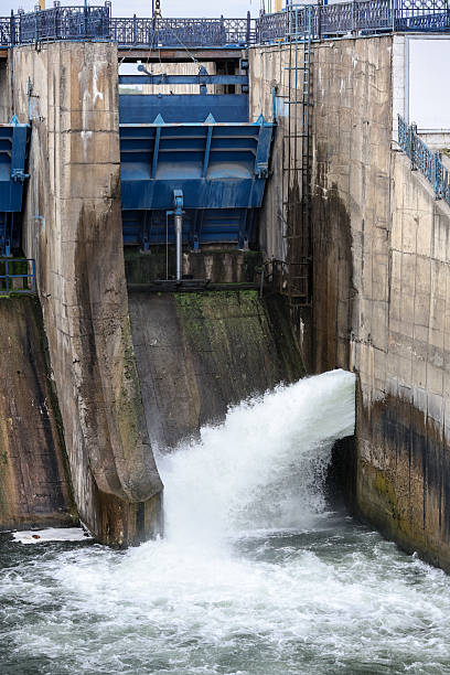 istock Overflow gate opened on a big concrete dam. Large volume of water flowing at high pressure. 2224476607