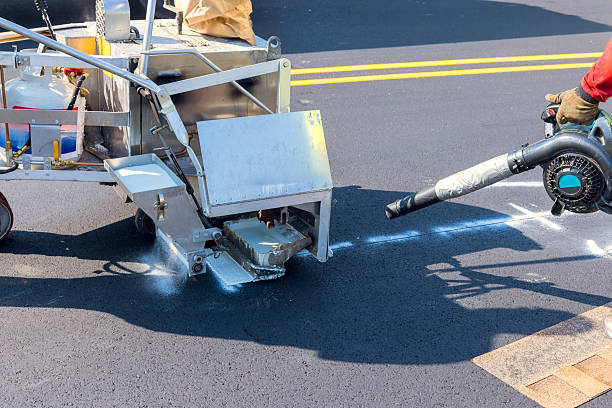 istock Road workers applying road striping paint using specialized equipment during works day hours in an urban setting 2224478985