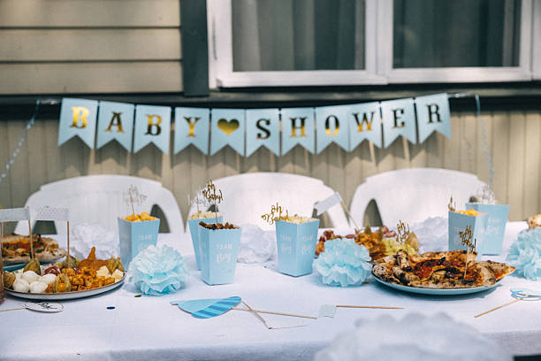 istock Festive baby shower celebration with decorative table and food display in a cozy setting 2224480188