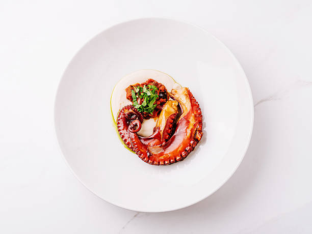 istock Deliciously cooked octopus served elegantly on a white plate with garnishing 2224482733