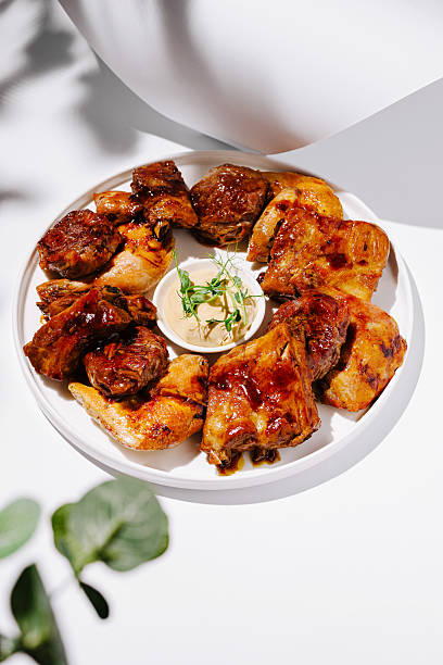 istock Delicious grilled chicken served on a white plate with dipping sauce 2224483258