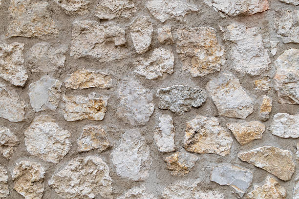 istock Rough stone wall texture with beige and white tones 2224485330