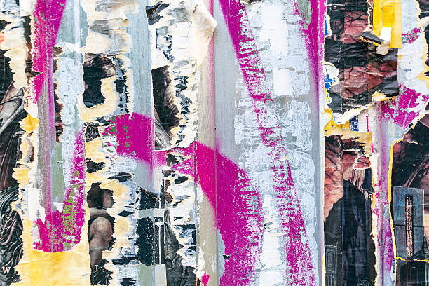 istock Vibrant urban collage of peeling posters and graffiti layers on wall 2224485357