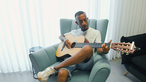 istock Musician practicing and composing new songs in his living room 2224485891