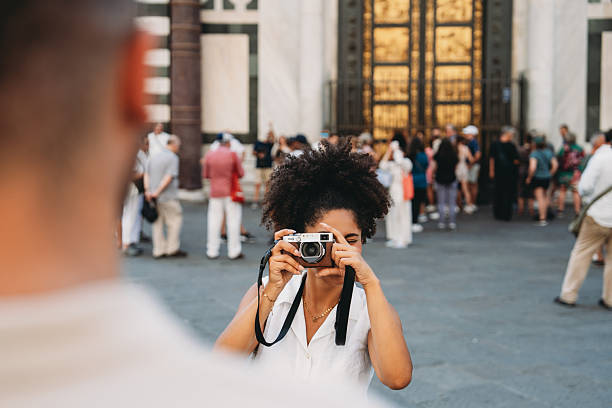 istock Young Woman Capturing Memories in a Busy Square 2224487091