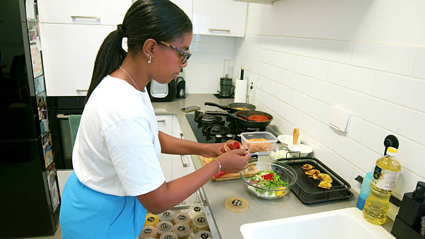 istock Young woman preparing a healthy meal in a modern kitchen 2224488547