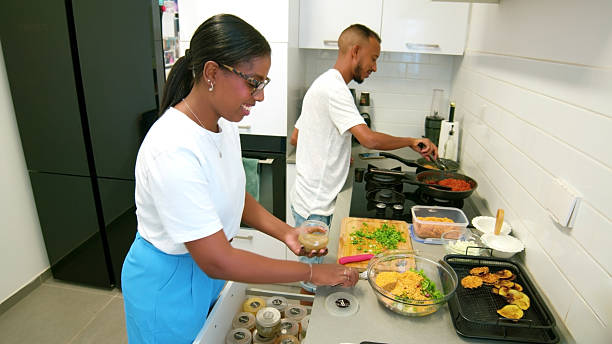 istock Young Adults Cooking Together in Modern Kitchen 2224488606