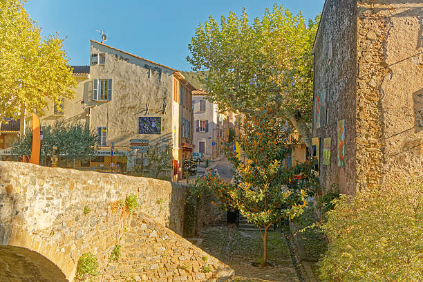 Collobrières and the massif of the Maures are a perfect holiday destination to combine picturesque villages with mountains and seaside. The photos shows an idyllic street view with Mediterranean flair in Collobrières on a sunny summer day