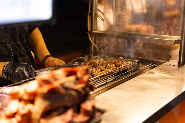 Raw beef on the gridiron at Ningxia night market in Taipei close up