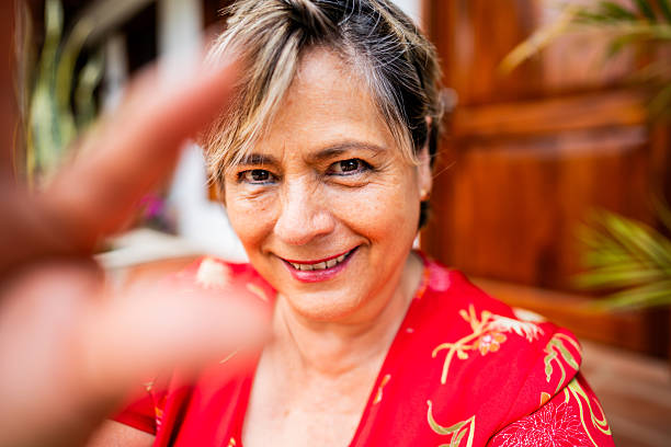 istock Happy senior woman touching camera 2224491488