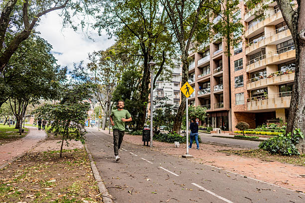 Young gay man running in the town square