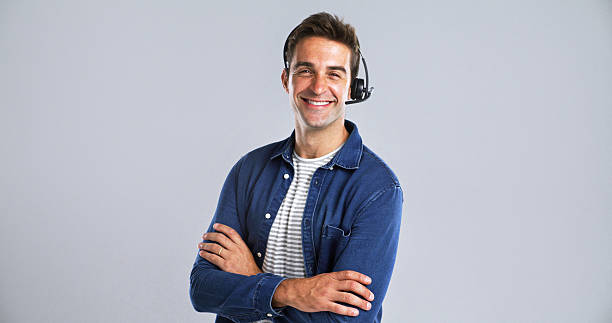 istock Happy man, portrait or consultant with headset or confidence in studio on a white background. Male person, agent or tech with smile or arms crossed for online customer service or CRM on mockup space 2224496582
