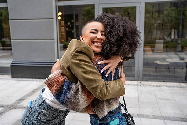 istock Two young women hugging in the city 2224498949