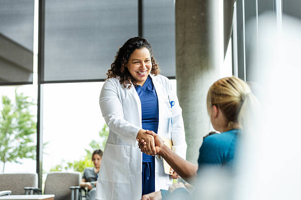 istock Friendly Doctor and Patient Handshake in Clinic Lobby 2224499417