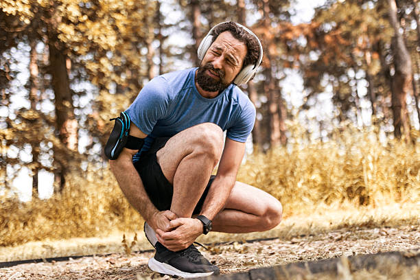 istock Man Experiencing Ankle Pain During Outdoor Jogging Session 2224500380