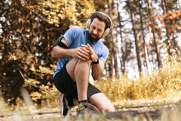 istock Man Experiencing Knee Pain During Outdoor Jogging Session 2224500418