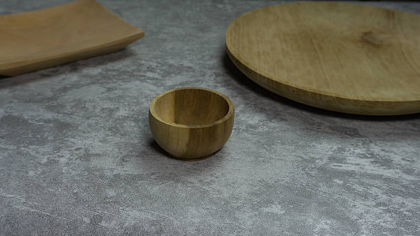istock Wooden plate and bowl combo on gray backdrop, rustic tableware set with natural texture in minimal neutral setting, perfect for culinary mockups 2224500684