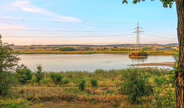istock Landscape with Lake and Power Lines 2224502831