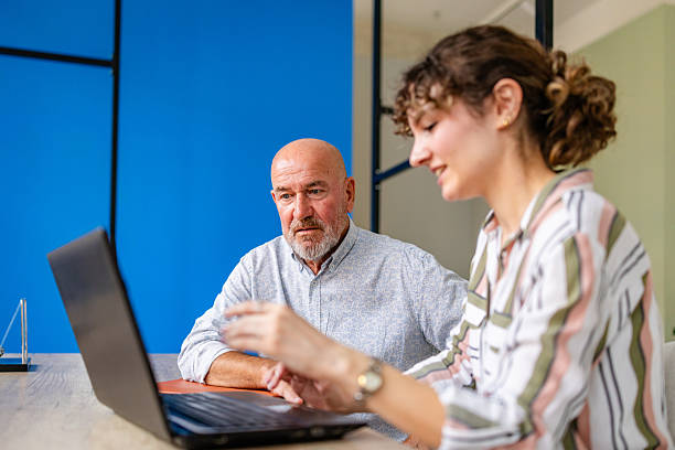istock Senior business executive collaborating with female workers in a modern office environment during a strategic meeting 2224503857