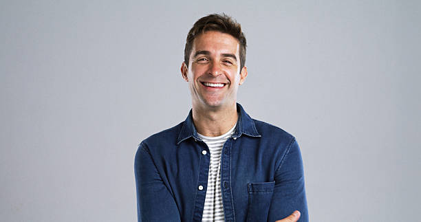 istock Creative, happy man or portrait with confidence or positive attitude in studio on a gray background. Male person, model or designer with smile in denim jacket for fashion or style on mockup space 2224508035