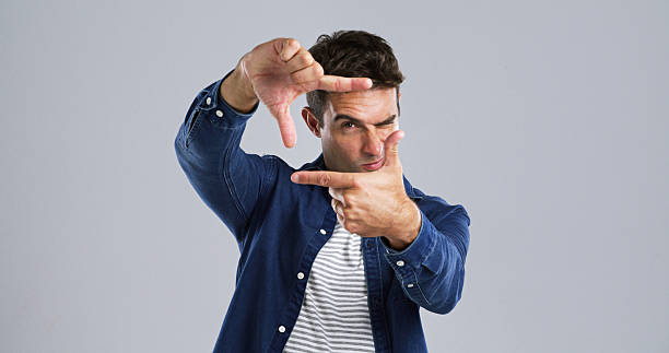 istock Studio, portrait and man with frame, confident or border with hands for photography or mockup space. White background, fashion and person with pride for post, social media or sign for profile picture 2224508087