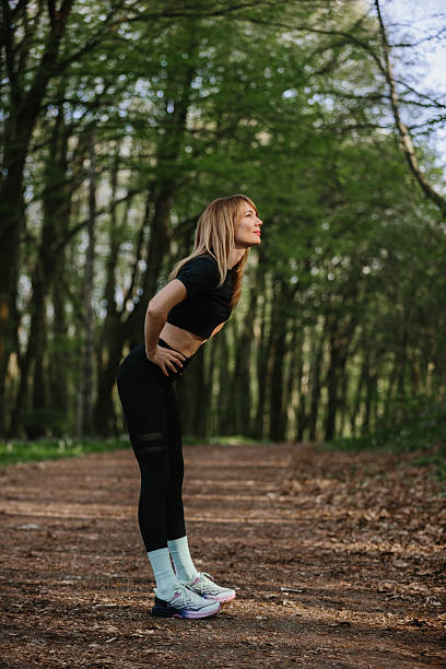 istock Woman enjoying outdoor exercise in forest setting 2224508628