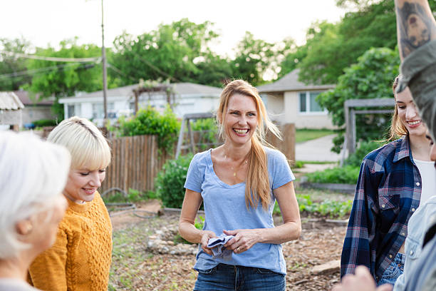 istock Community garden group therapy session outdoors, happy women talking 2224508882