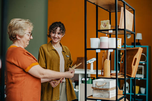 istock Young woman engages with a customer at a vibrant gift shop while showcasing unique items for sale 2224510044
