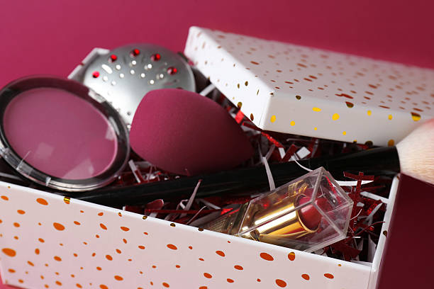 istock Christmas gift box with decorative cosmetics on dark pink background, closeup 2224512505