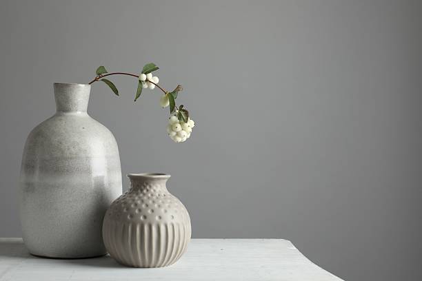 istock Stylish vases and snowberry branch on white table, space for text 2224512571