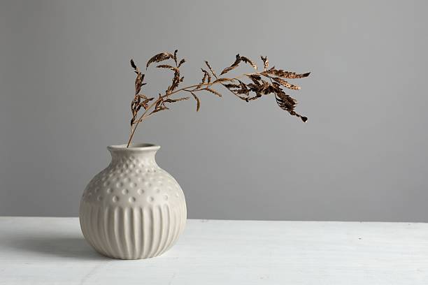 istock Stylish vase with dry branch on white table 2224512600