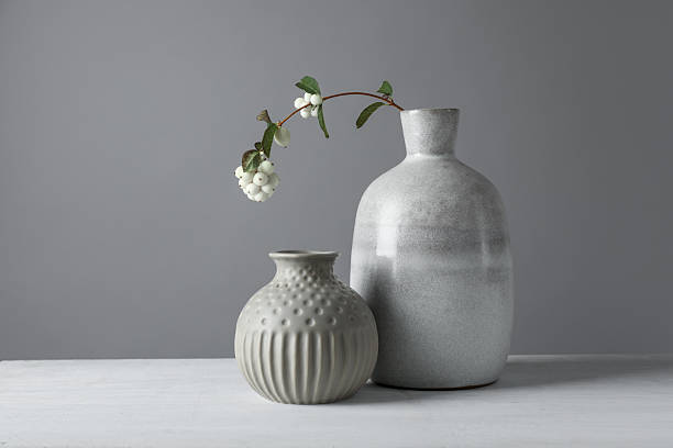 istock Stylish vases and snowberry branch on white table 2224512667