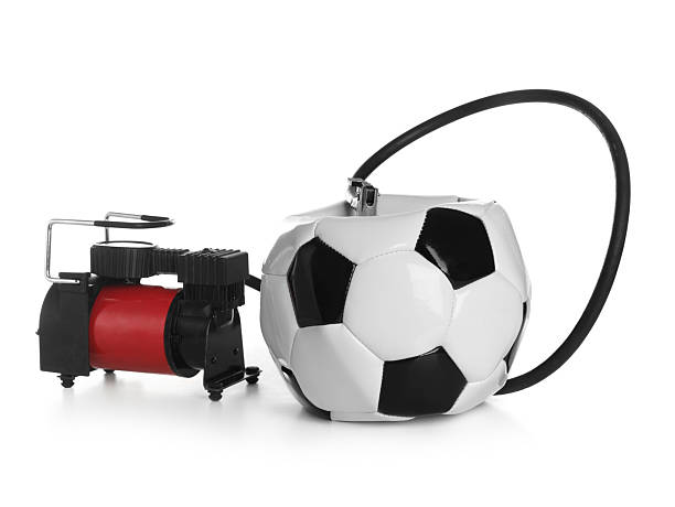 istock Deflated soccer ball and air compressor isolated on white 2224514021