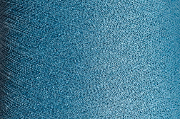 istock Clear image of texture of blue threads. Spool of colored blue threads. Cotton threads for knitting. Textile backdrop. 2224514435
