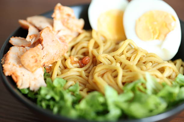 Japanese ramen with egg on black bowl in close-up