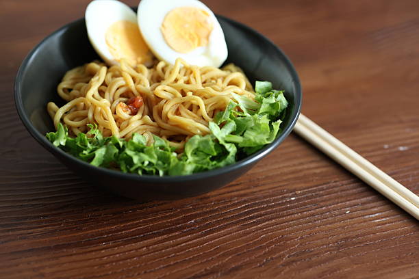 Japanese ramen with egg on black bowl in close-up